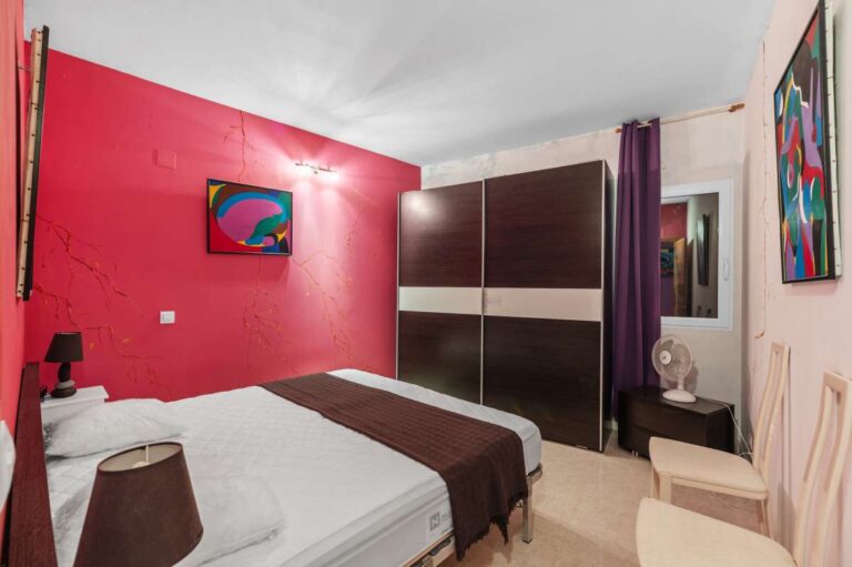 Double bedroom inside an independent apartment of a Benissa sea view villa with fitted wardrobe, window and bright interior finish