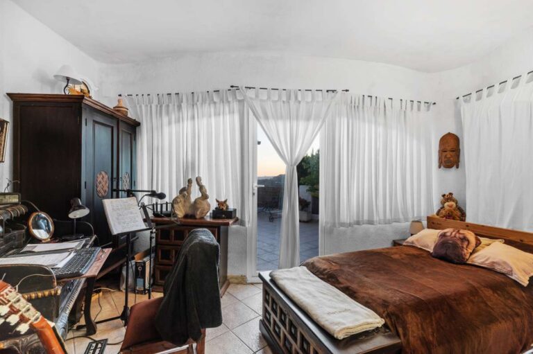 Double bedroom inside an independent apartment of a Benissa sea view villa with terrace access, desk area and bright interior finish