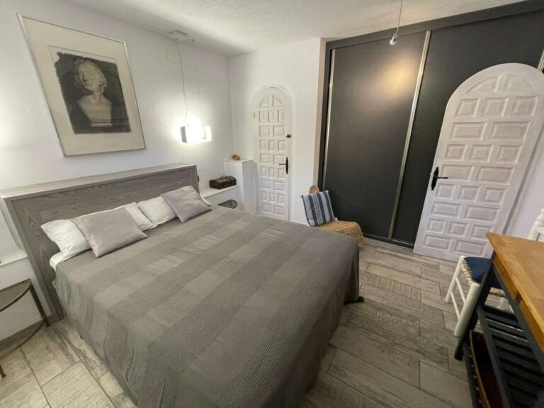 Double bedroom with fitted wardrobes and traditional door detail inside a refurbished villa in Canuta, Calpe.