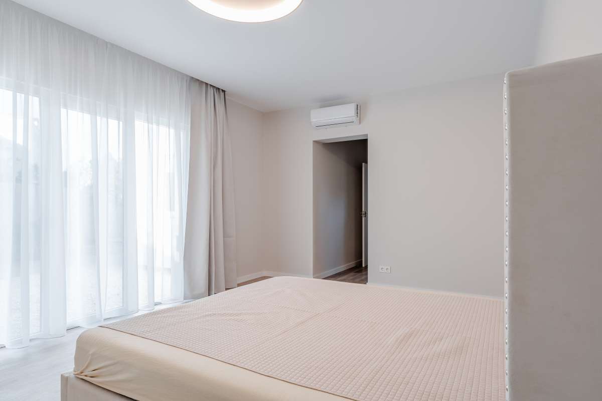 Double bedroom with large curtains and air conditioning inside a new build villa in Calpe