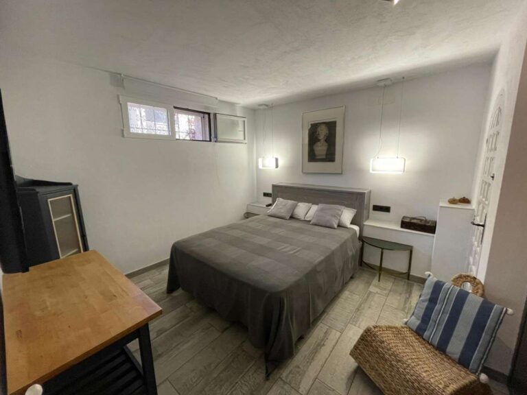 Double bedroom with natural light and traditional furniture inside a refurbished villa in Canuta, Calpe.