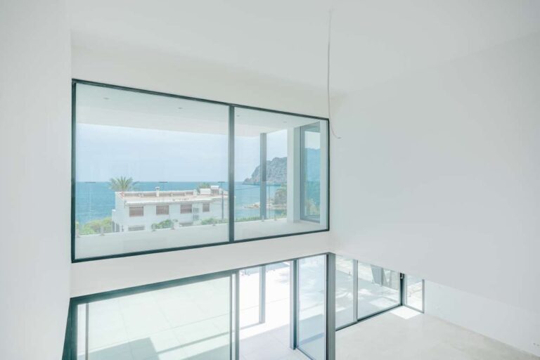 Double-height interior inside a modern villa in La Calalga, Calpe with large windows, sea views and contemporary architectural design