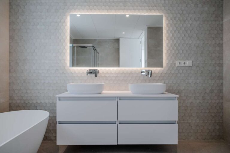 Double vanity bathroom inside a modern villa in La Calalga, Calpe with illuminated mirror, freestanding bath and contemporary finish