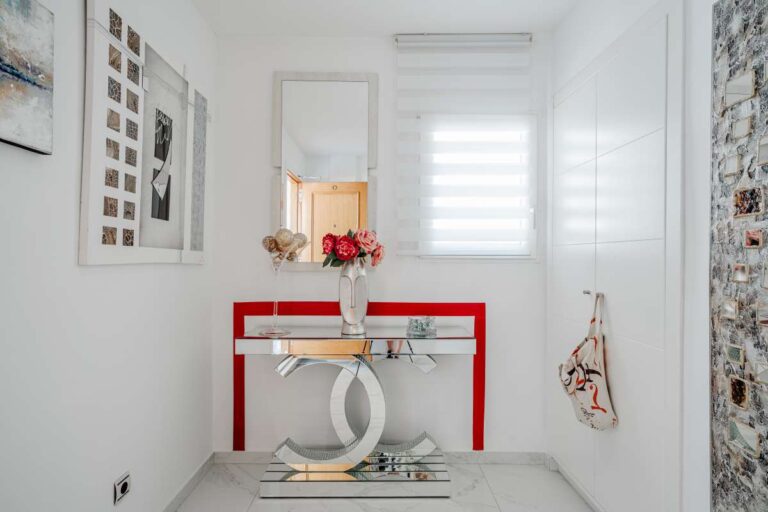 Dressing area inside a renovated apartment by Arenal-Bol Beach in Calpe with built-in storage and bright modern finish