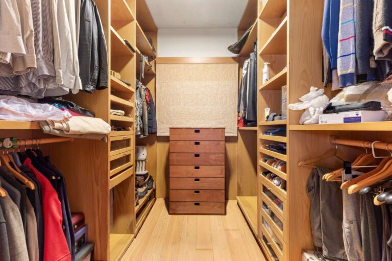 Dressing room inside a private villa in Calpe with built-in storage, hanging space and shelving