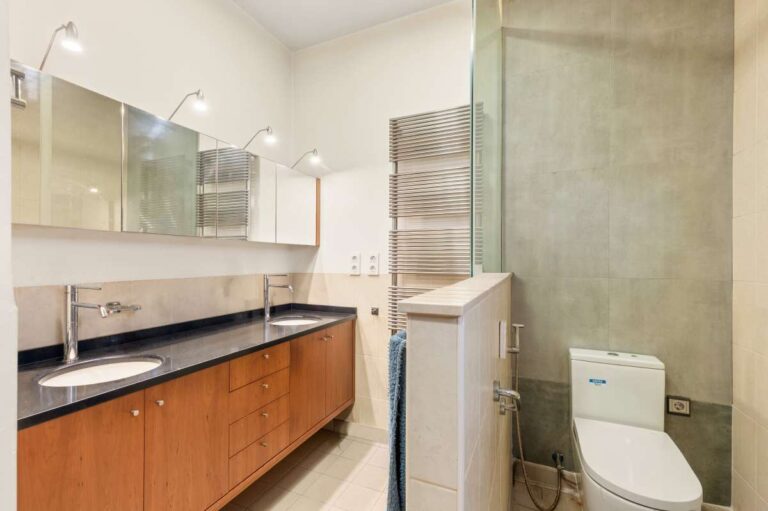 En-suite bathroom inside a private villa in Calpe with double vanity, toilet and modern tiled finish