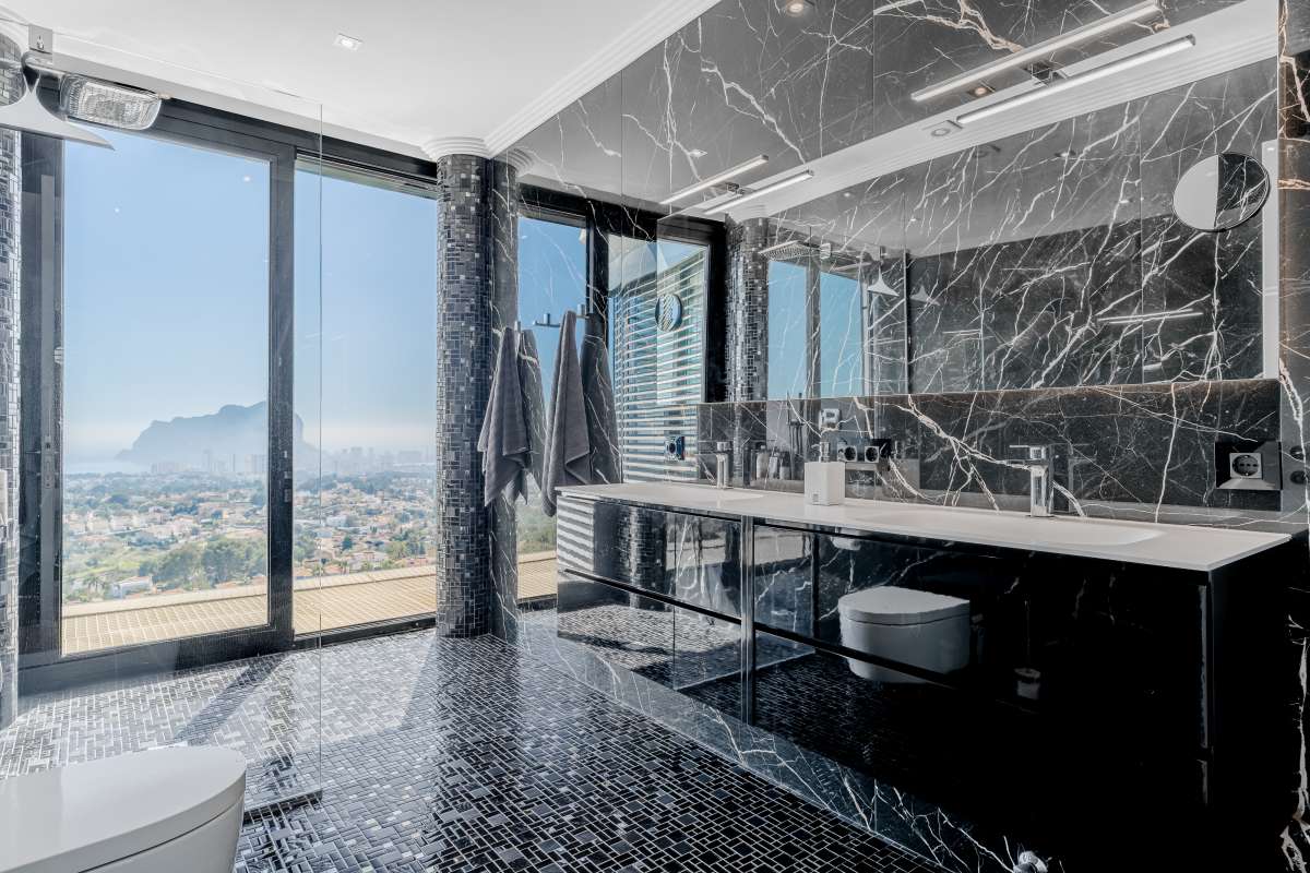 En-suite bathroom with black marble-style finishes, double vanity and panoramic views inside a luxury villa in Gran Sol, Calpe.