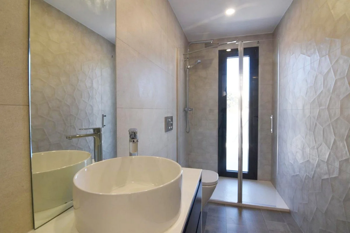 En-suite bathroom with walk-in shower and vanity in modern villa in Calpe