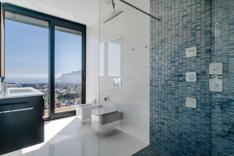 En-suite bathroom with walk-in shower, vanity and panoramic sea views inside a luxury villa in Gran Sol, Calpe.