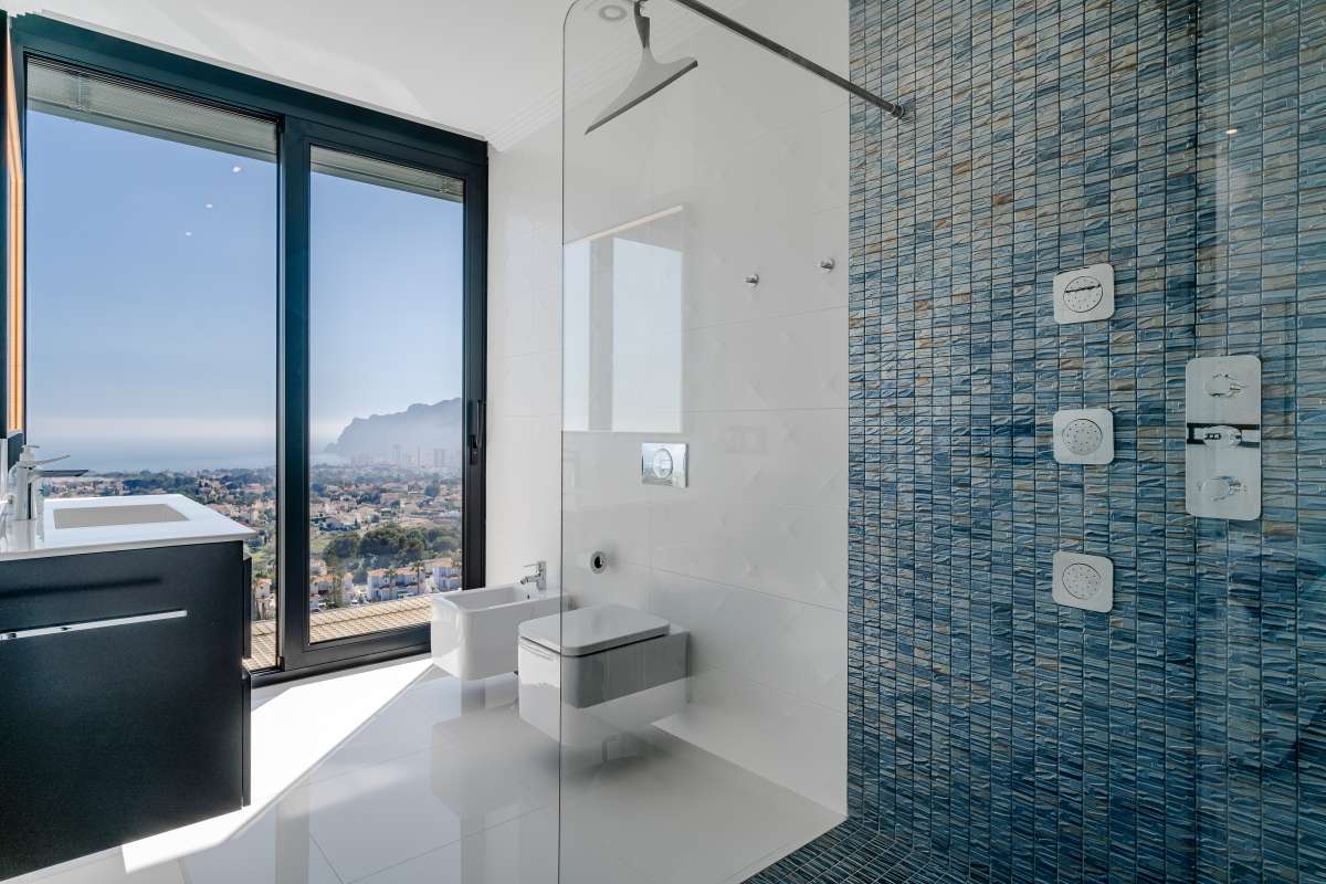En-suite bathroom with walk-in shower, vanity and panoramic sea views inside a luxury villa in Gran Sol, Calpe.