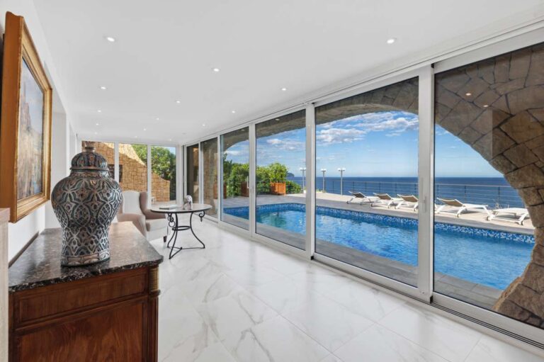 Enclosed terrace at a premium coastal villa on the Benissa Costa with pool views, panoramic sea views and large sliding glass doors