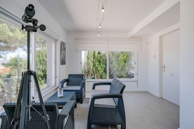 Enclosed terrace seating area inside a modern villa in Calpe with large windows and open views