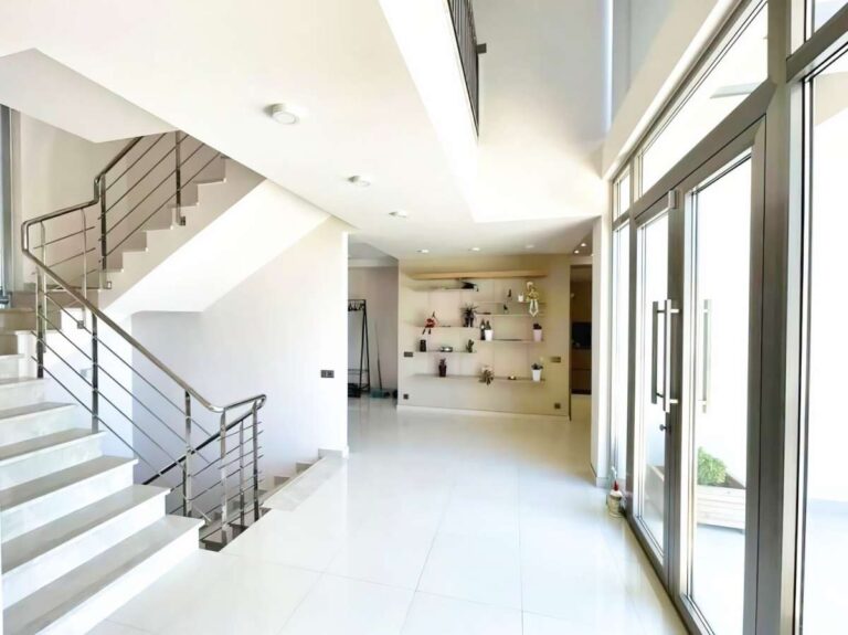 Entrance hall inside a modern luxury villa in La Calalga, Calpe with staircase, large windows and bright open interior design