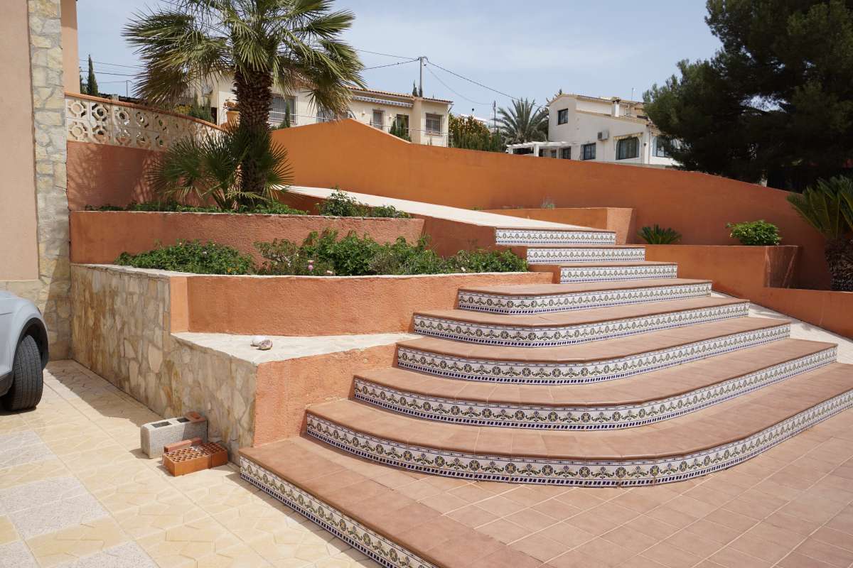Entrance steps, driveway and exterior wall at a Mediterranean villa in Calpe near La Calalga Beach.