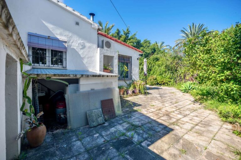 Exterior of a Mediterranean villa in Benissa Costa near Cala Baladrar with driveway, garage access, garden area and renovation potential
