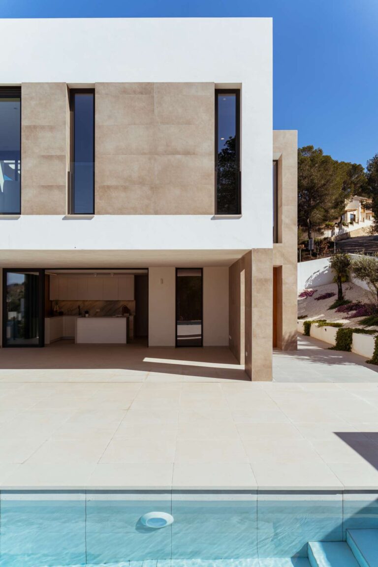 Exterior of a new-build luxury villa in Moraira with infinity pool, large terrace, stone façade and contemporary design