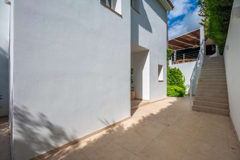 Exterior stairs at a modern villa in Altea Hills with white façade, side terrace access, shaded walkway and Mediterranean planting