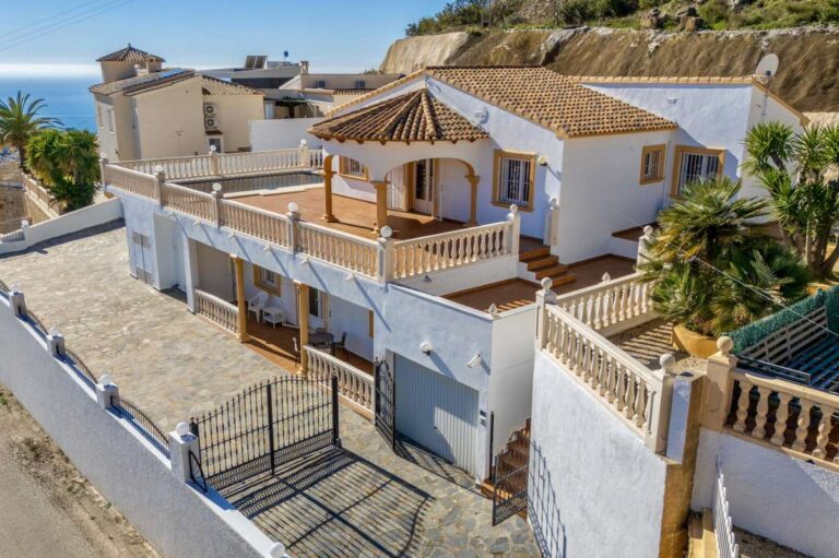Exterior view of a villa in Calpe with terraces, private pool area, and raised residential surroundings.