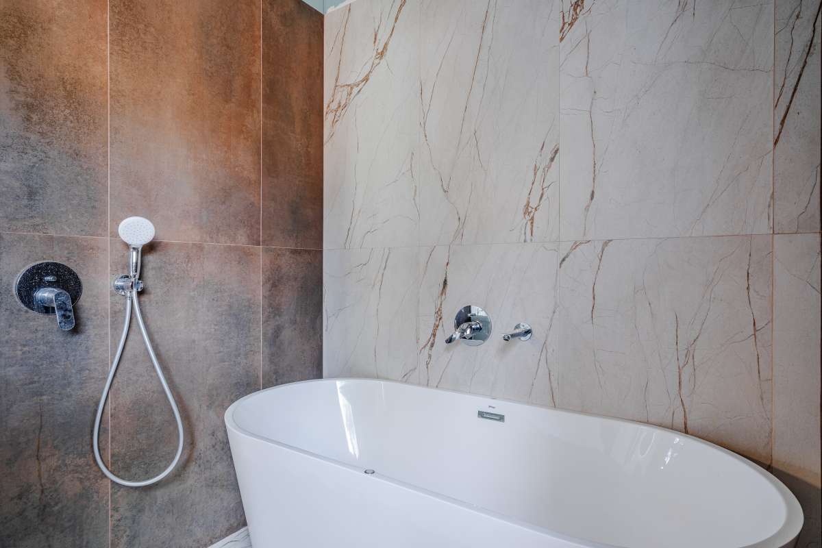 Freestanding bath with modern wall tiles inside a new build villa near the coast in Calpe