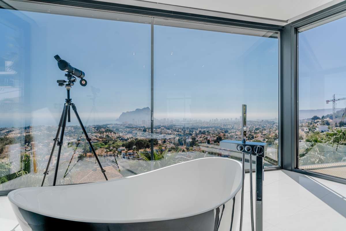 Freestanding bathtub with panoramic views towards the Peñón de Ifach inside a luxury villa in Gran Sol, Calpe.
