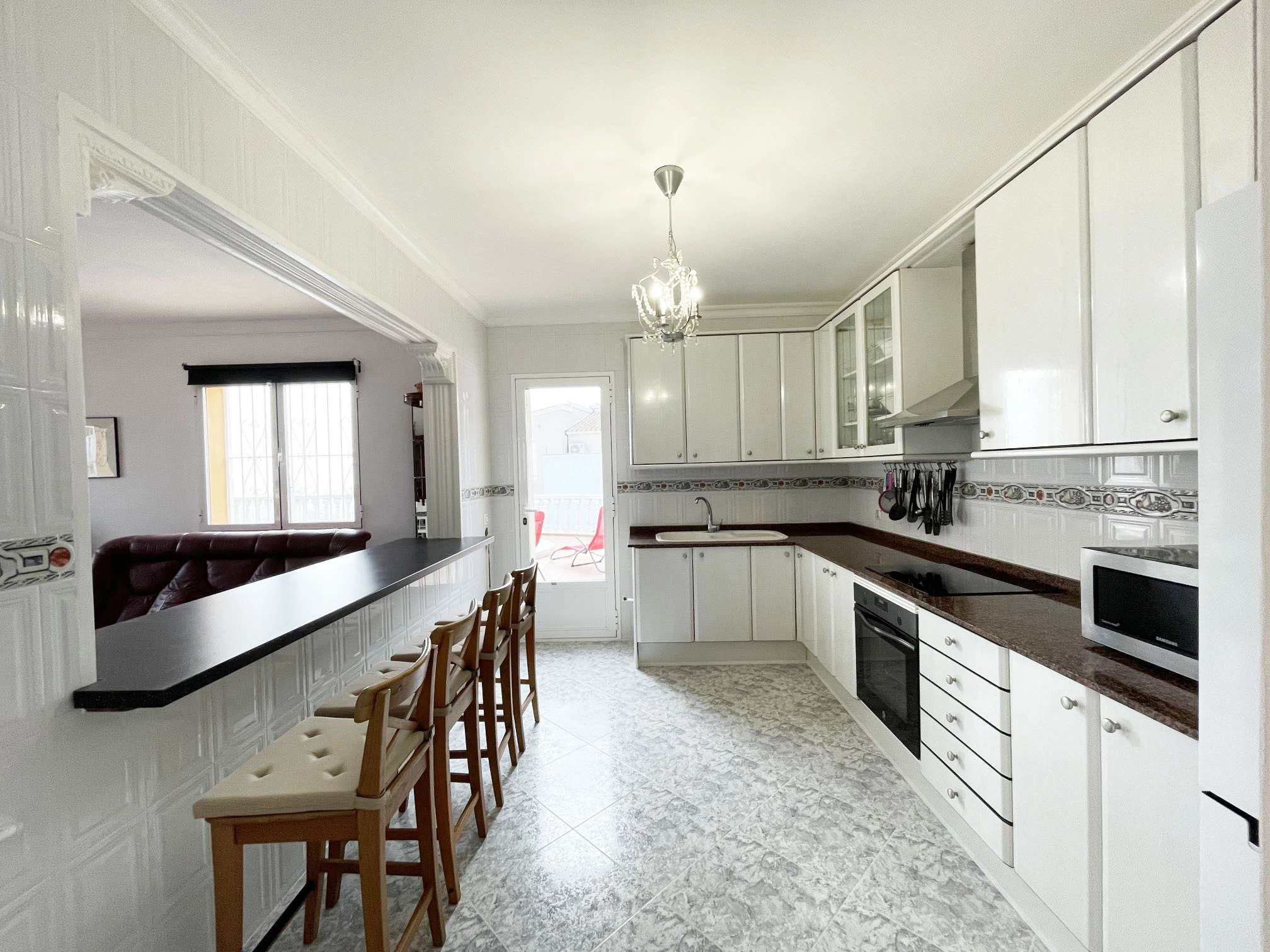 Fully equipped kitchen connected to living room at detached villa in Calpe