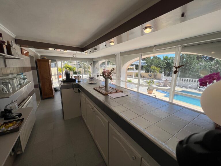 Fully equipped kitchen with pool views at Mediterranean villa in Benissa