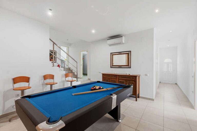 Games room with pool table and seating area inside the lower level of a villa in Calpe.