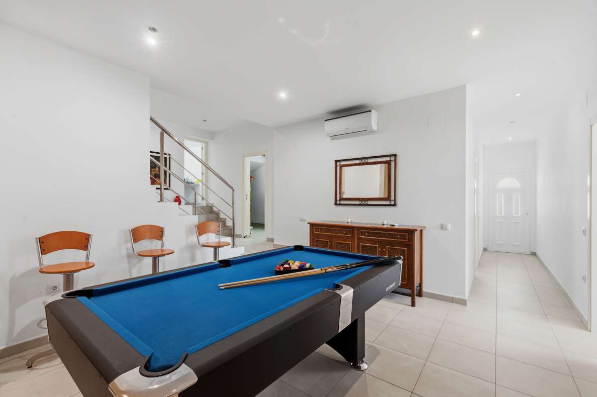 Games room with pool table and seating area inside the lower level of a villa in Calpe.