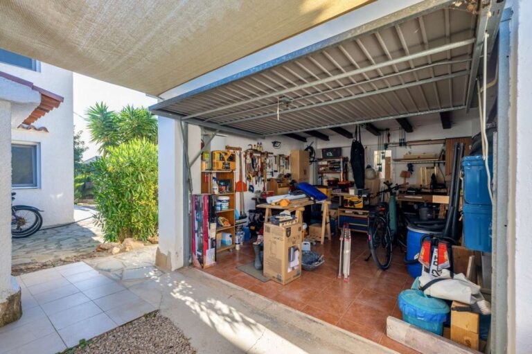 Garage and storage area at a contemporary villa in Calpe with space for vehicles and household items.