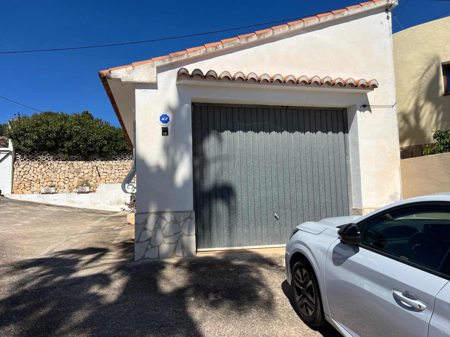 Garage entrance and parking area at Mediterranean villa in Benissa