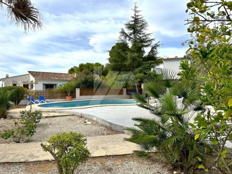 Garden and pool area at a single-level villa near El Portet Beach in Moraira with private swimming pool, Mediterranean planting and terrace space
