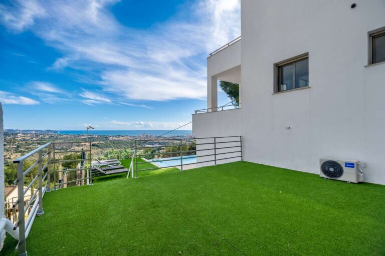 Garden area with panoramic sea views beside a modern spacious villa in Calpe.