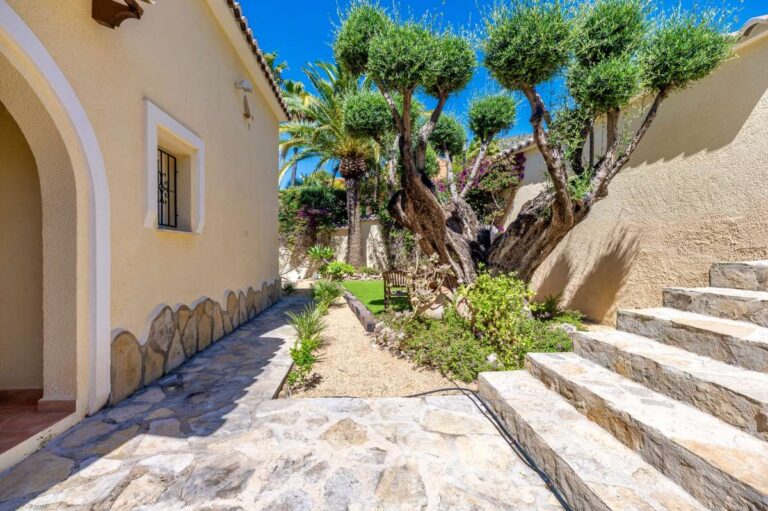 Garden path at an elegant Mediterranean villa in Altea Hills with stone paving, mature olive trees, steps and Mediterranean planting