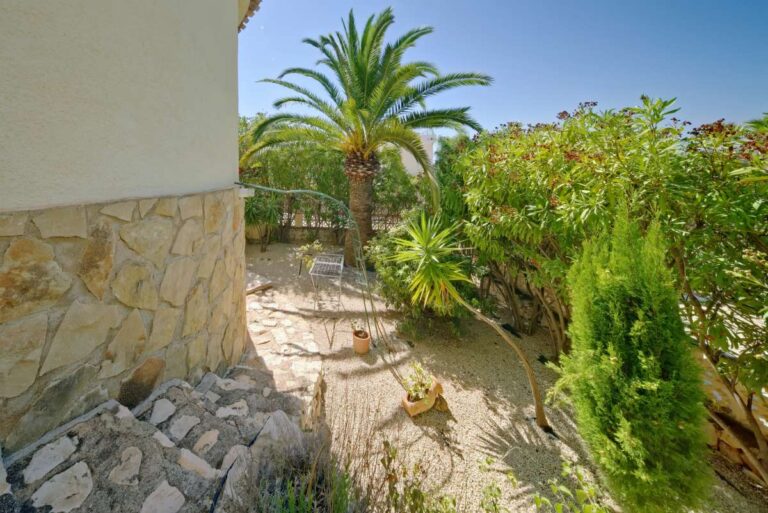 Garden pathway with Mediterranean planting beside a second line villa near Puerto Blanco in Calpe.