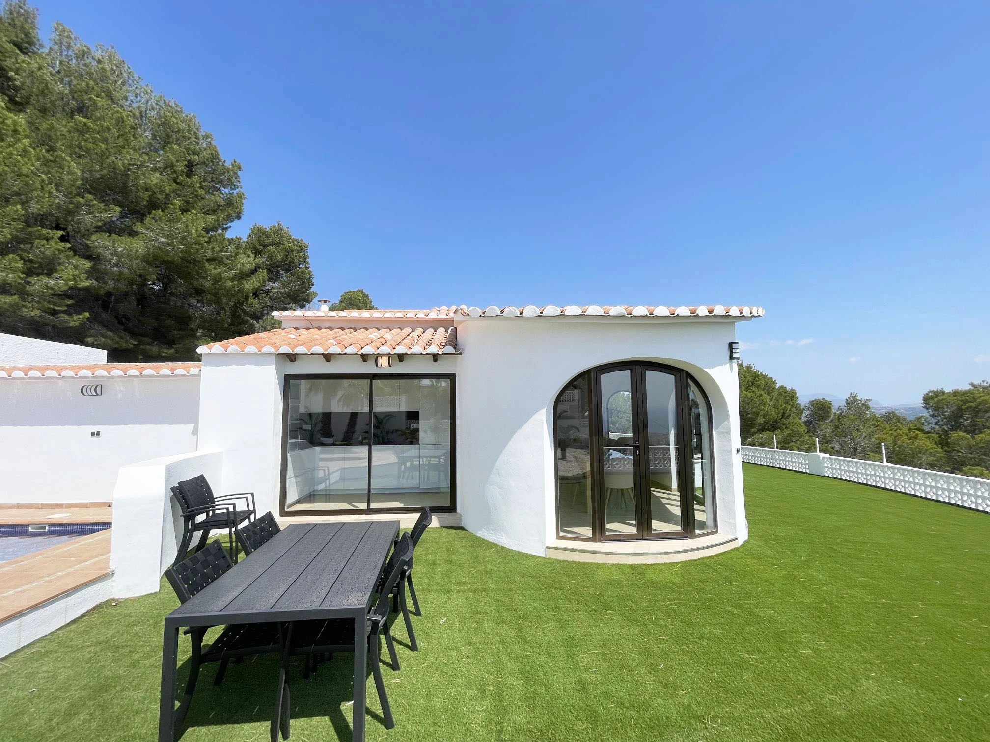 Garden terrace and white villa exterior in Oltamar, Calpe