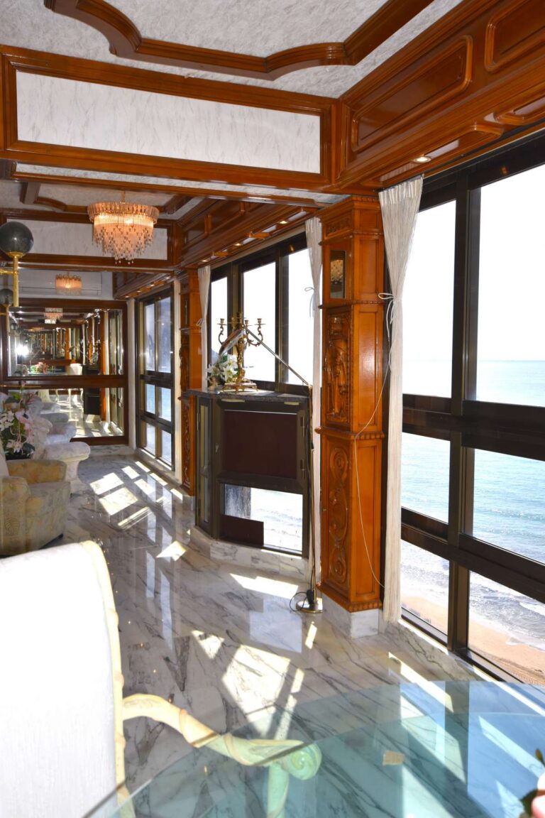 Glazed terrace lounge with sea views and quality finishes inside a frontline double penthouse on Arenal Beach in Calpe.