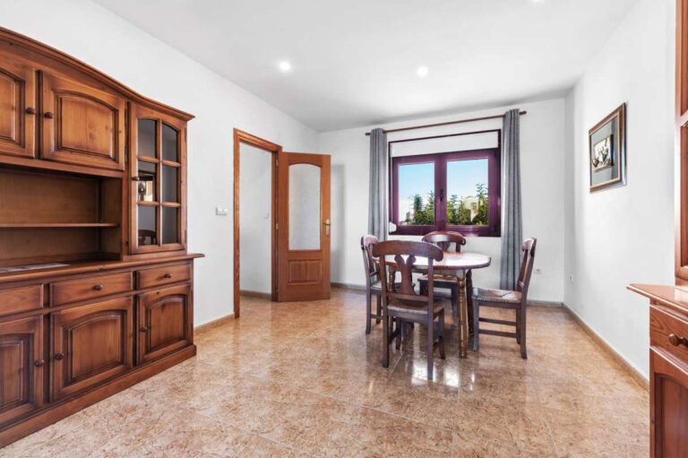 Guest apartment lounge and dining area with wooden furniture and natural light inside a spacious villa in Calpe.
