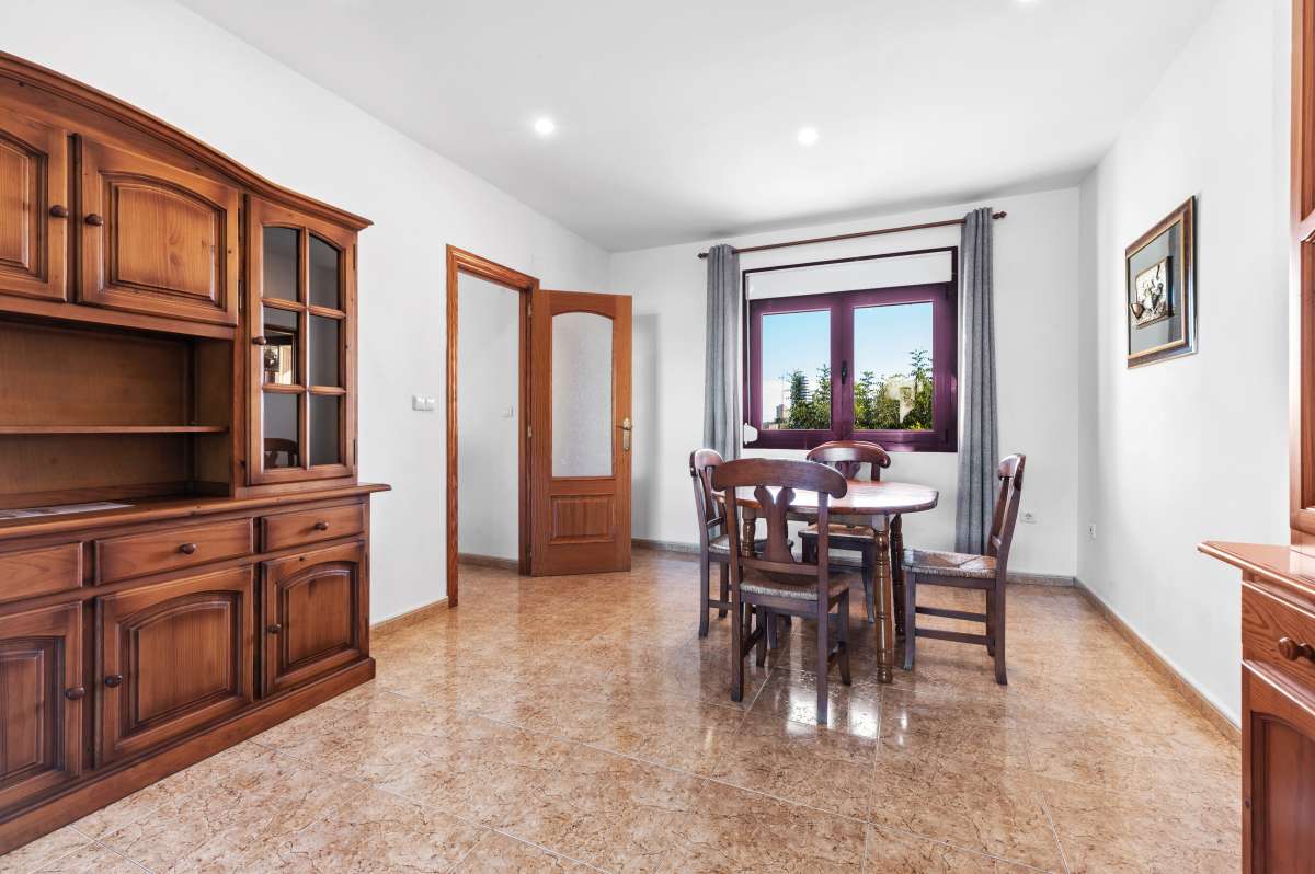 Guest apartment lounge and dining area with wooden furniture and natural light inside a spacious villa in Calpe.