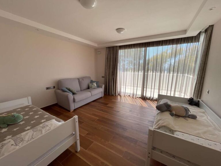Guest bedroom inside a modern luxury villa in La Calalga, Calpe with wooden flooring, large windows and bright contemporary finish