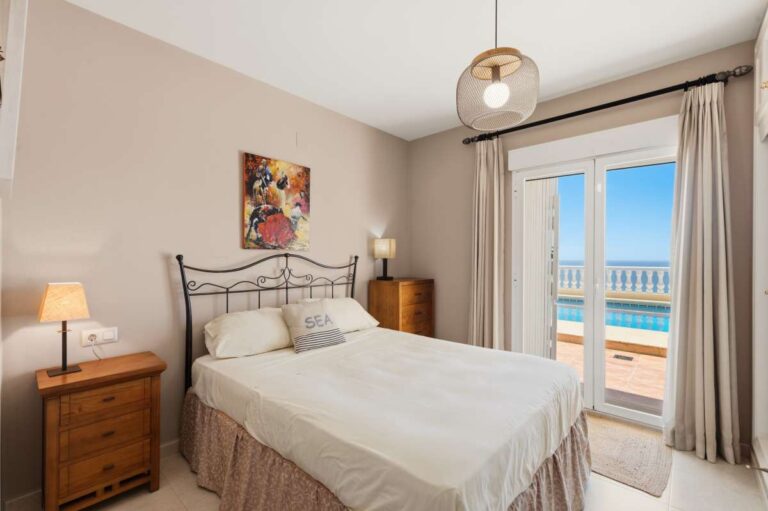 Guest bedroom inside an elegant Mediterranean villa in Altea Hills with direct access to the pool terrace and bright natural light