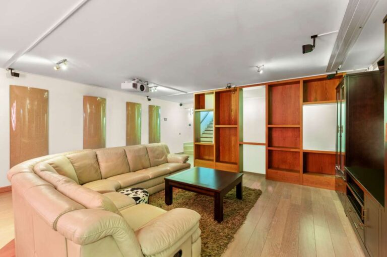 Guest living area inside a private villa in Calpe with sofa seating, fitted storage, TV area and independent accommodation setup