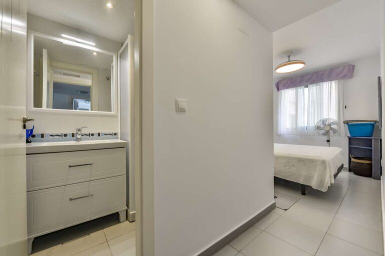 Hallway inside a beachfront apartment in La Fossa, Calpe with bathroom vanity area and bedroom access