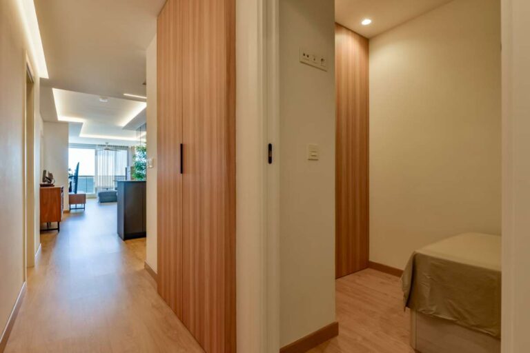 Hallway inside a luxury frontline beach duplex in Mascarat, Altea with bedroom access, wood-effect flooring and modern interior finish