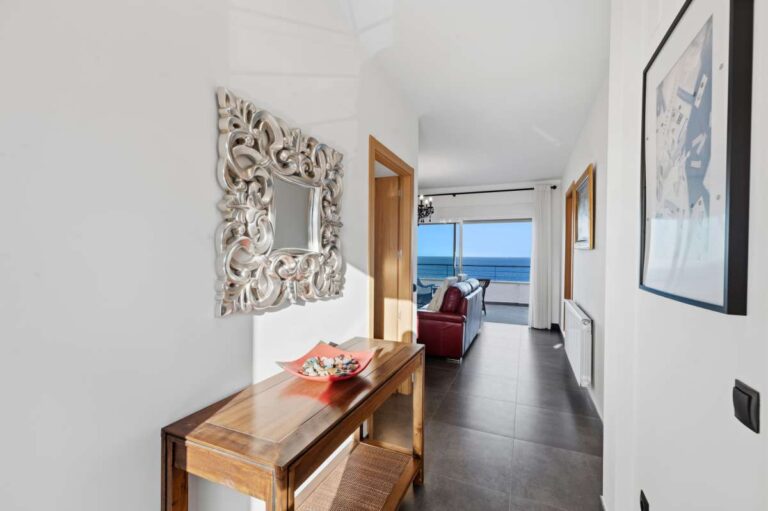 Hallway inside a premium coastal villa on the Benissa Costa with decorative mirror, bright interior finish and sea views through the living area