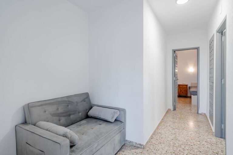 Hallway with small lounge area inside an independent apartment at a Mediterranean villa in Maryvilla, Calpe.