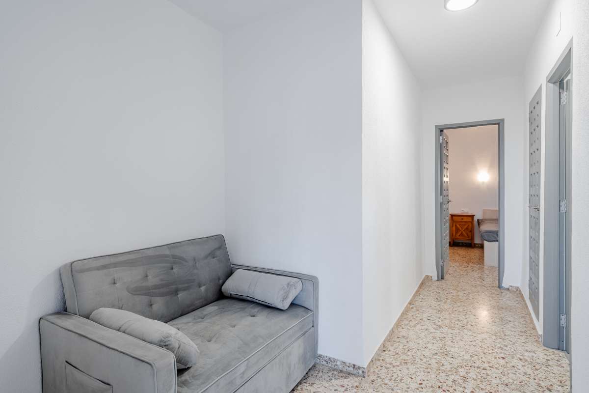 Hallway with small lounge area inside an independent apartment at a Mediterranean villa in Maryvilla, Calpe.