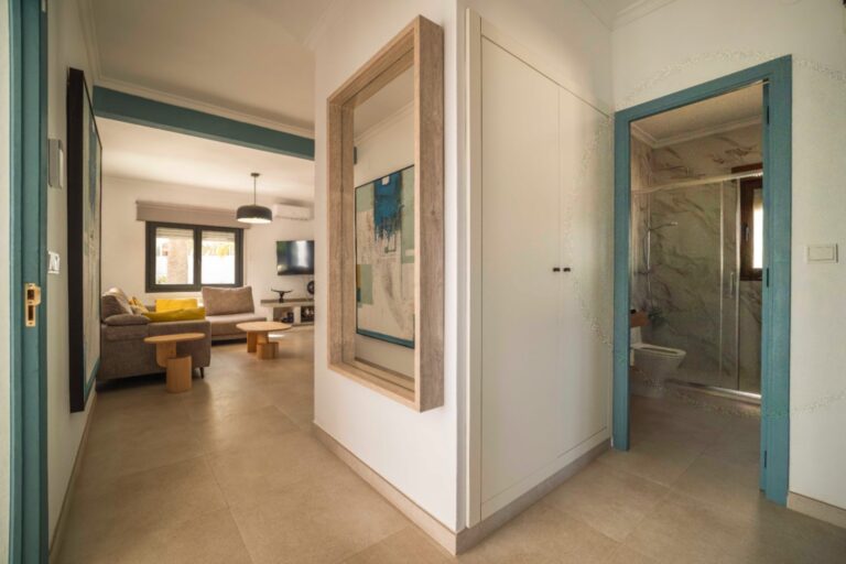 Hallway with turquoise doors inside Ibiza-style villa in Calpe