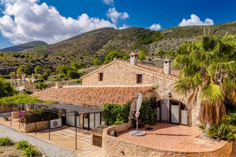 Historic finca in Benissa with stone exterior, tiled roof, Mediterranean planting and mountain views in the surrounding countryside