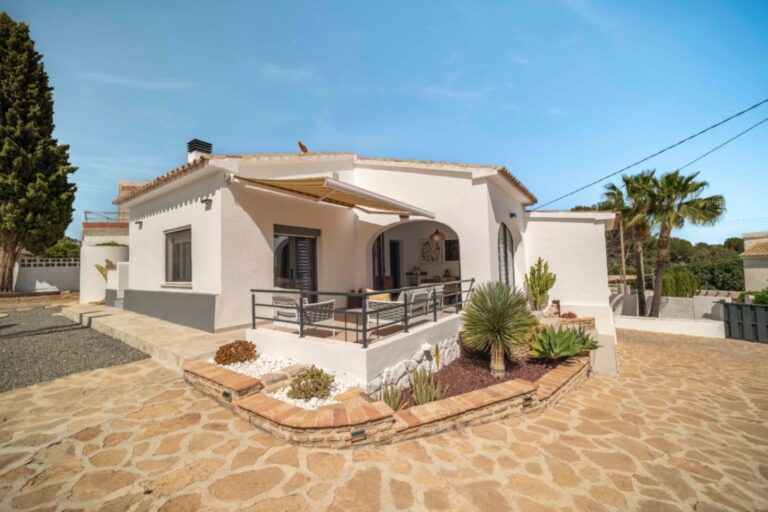 Renovated Ibiza-style villa exterior with stone terrace in Calpe