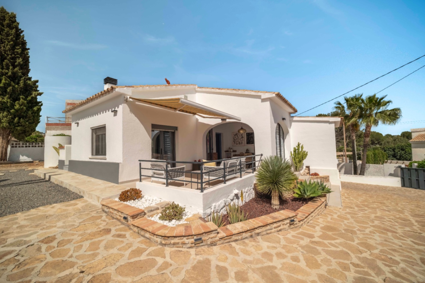 Renovated Ibiza-style villa exterior with stone terrace in Calpe